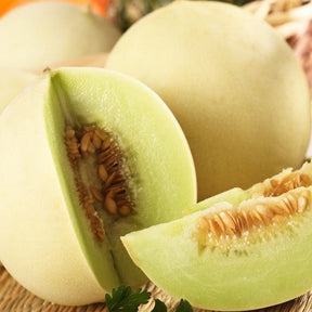 Green flesh honeydew melon seeds from SeedsNow, shown in close-up with vibrant green flesh and seed details.