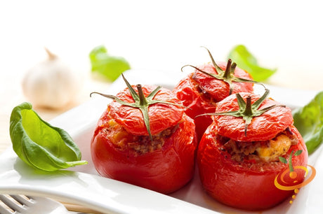 Red Caribe determinate tomato seeds from SeedsNow, shown in a close-up image of ripe tomatoes on the vine.